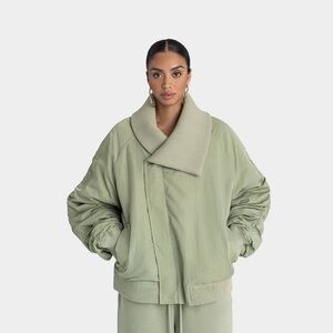 Women’s oversized green puffer jacket with rubber detailing and zipper closure